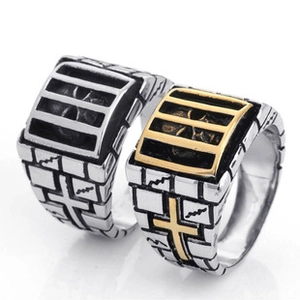 Detail showing two-tone square steel rings with skull and cross patterns for men