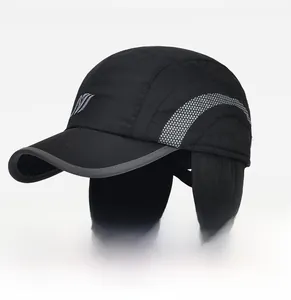 Detail of winter baseball cap with ear flaps featuring reflective tape and embroidery