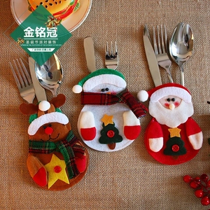 Detail of Santa, Snowman and Reindeer felt cutlery holders with star and button accents
