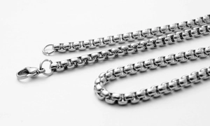 Macro detail of 304 stainless steel box chain with lobster clasp on white background