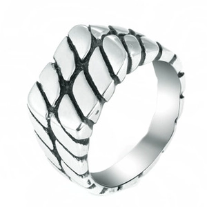 Detailed close-up of a wide square titanium steel ring with vintage fish scale texture