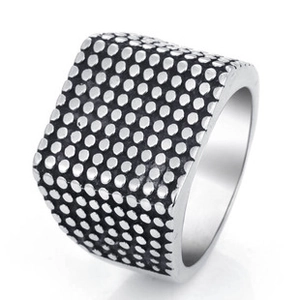 Detail shot of men's wide silver titanium steel ring with black dot matrix texture