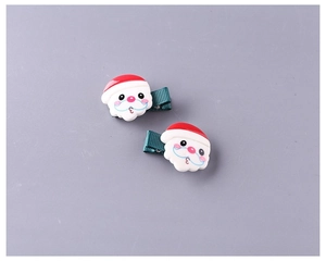 Dettaglio di fermagli per capelli Babbo Natale per bambini con nastro grosgrain verde