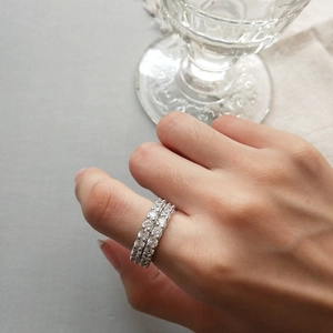 Close-up of stacked S925 sterling silver eternity rings with round zircon stones