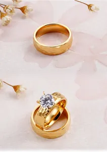 Detail of 18K gold-plated titanium steel rings with hammered texture and zircon inlay