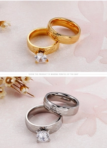 Detail of 18K gold and silver rings with hammered texture and sparkling solitaire zirconia