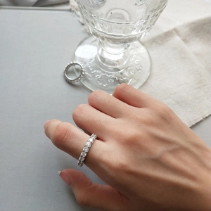 Close-up of minimalist S925 sterling silver ring with continuous pavé cubic zirconia