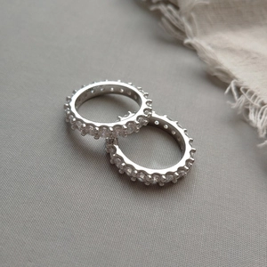 Close-up of S925 sterling silver eternity rings with sparkling cubic zirconia stones