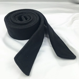 Close-up of black wool coat belt showing soft texture and premium material finish