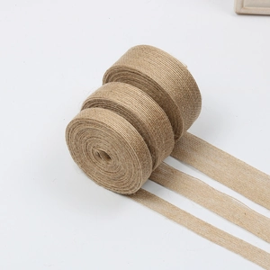 Close-up of three widths of natural jute ribbon rolls for DIY gift packaging