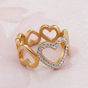 Golden hollow heart ring with sparkling zircon stones from a 45-degree angle