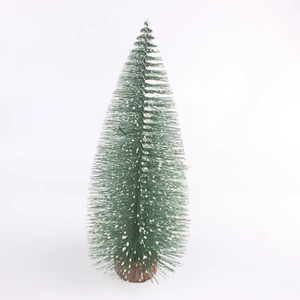 Detail of mini frosted Christmas tree with green bristles and a round wooden base