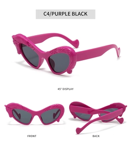 Macro detail of magenta heart sunglasses with winged frame and gray lenses in C4 purple black