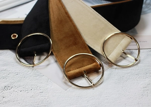 Detail view of velvet corset belts with round gold metal buckles in black brown and beige