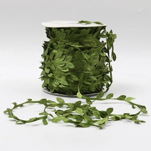 Detail shot of green leaf ribbon roll for gift packaging and DIY decoration