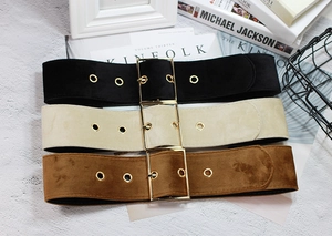 Three suede wide waist belts in black, beige, and brown with large gold square buckles