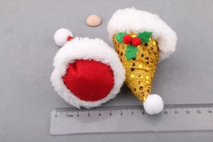 DIY Christmas hair clip parts with mini red felt and gold sequined hats on ruler scale