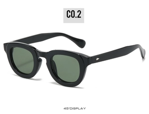 Detail view of black thick frame sunglasses with silver diamond rivets and green lenses