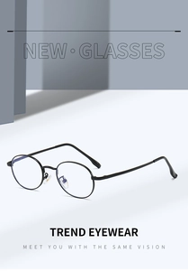 Close-up of retro oval blue light blocking glasses with minimalist black metal frame
