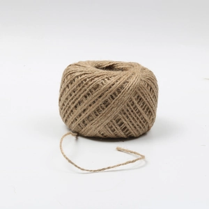 Macro detail of 1.5mm brown natural jute twine roll with visible fiber texture