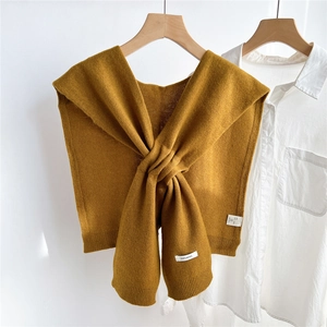 Detail of 100% wool knitted shawl featuring high-quality mustard yellow fabric texture