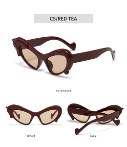 Macro detail of red tea cat-eye sunglasses with unique feather relief and heart design