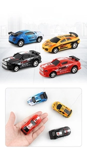 Mini remote control racing cars in four colors shown with hand for scale comparison