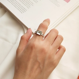 Detail of S925 sterling silver chain ring with square grey zircon on woman's finger