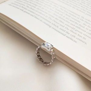 Macro shot of silver S925 sterling silver chain ring with rectangular cubic zirconia stone