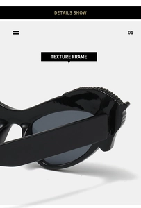 Close-up of black glossy sunglasses frame showing detailed textured gear pattern on top
