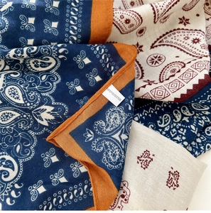 Detailed close-up showing 100% polyester fabric texture and paisley pattern scarf