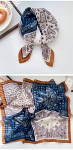 Detailed macro view of a paisley pattern square scarf in navy blue and caramel brown
