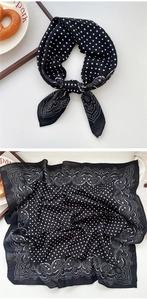 Close-up of black and white square scarf with paisley patterns and polka dot details