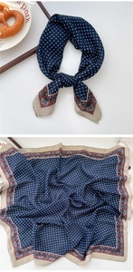 Detail view of navy blue square scarf with vintage geometric prints and floral borders