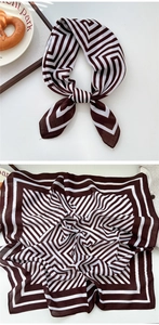 Detail view of brown and white geometric striped square scarf with stylish knot and texture