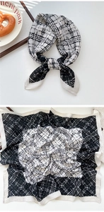 Detail of black and white checkered silk scarf showing flat layout and knotted styling