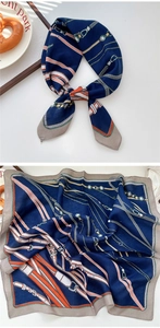 Detail of navy silk scarf with gold chain and belt patterns showing knots and textures