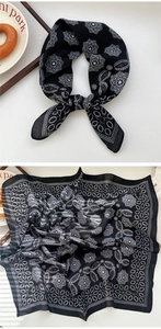 Detail showing classic black and white paisley print on soft silk square scarf and ribbon tie