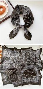 Macro detail of brown paisley square scarf with delicate white floral patterns and hemmed edges