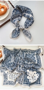 Detailed view of cream paisley pattern on a soft square neckerchief in retro style