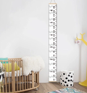 Detail of wooden canvas growth chart showing metric and imperial scales in nursery