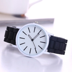 Close-up of Geneva white quartz watch with black silicone strap and minimalist dial