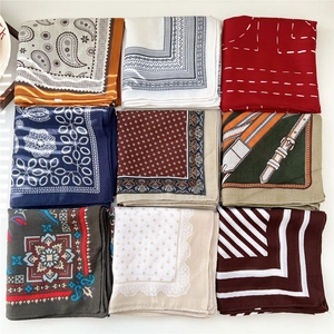 Collection of nine colorful paisley and geometric print square scarves for women