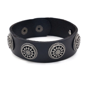 Mens black leather bracelet with round metal stud details and snap closure on white background