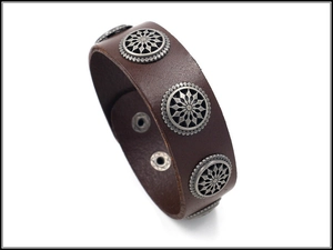Close-up of brown leather bracelet with silver floral studs and snap button closure