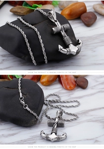 Detailed view of silver nautical anchor pendant with rope chain on stone background