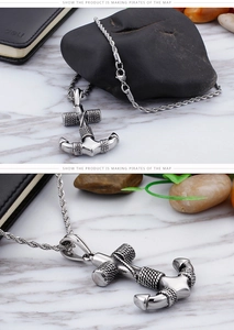 Macro shot of stainless steel anchor pendant with realistic rope texture on a rope chain