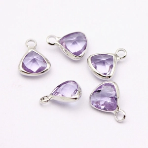Five light purple teardrop crystal pendants with silver metal frames on white background