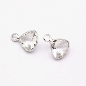 Detailed view of two triangle cut crystal birthstone pendants with silver claw settings