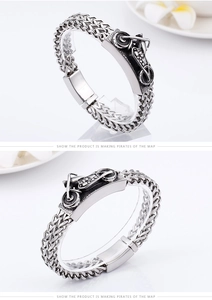 Macro detail of men's vintage biker chain bracelet with 3D motorcycle metal relief